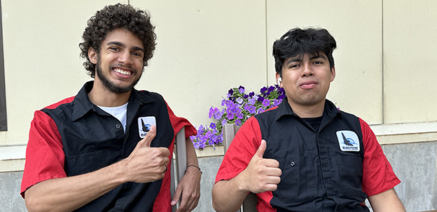 Students giving the thumbs up in the courtyard